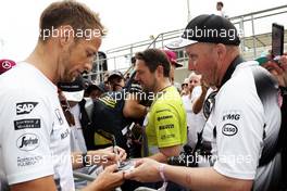 Jenson Button (GBR) McLaren signs autographs for the fans. 07.07.2016. Formula 1 World Championship, Rd 10, British Grand Prix, Silverstone, England, Preparation Day.