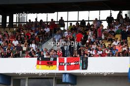 Sebastian Vettel (GER) Ferrari and Kevin Magnussen (DEN) Renault Sport F1 Team fans in the grandstand. 31.07.2016. Formula 1 World Championship, Rd 12, German Grand Prix, Hockenheim, Germany, Race Day.