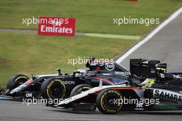 Fernando Alonso (ESP) McLaren MP4-31 and Sergio Perez (MEX) Sahara Force India F1 VJM09 battle for position. 31.07.2016. Formula 1 World Championship, Rd 12, German Grand Prix, Hockenheim, Germany, Race Day.