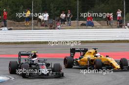 Jenson Button (GBR) McLaren MP4-31 and Kevin Magnussen (DEN) Renault Sport F1 Team RS16 battle for position. 31.07.2016. Formula 1 World Championship, Rd 12, German Grand Prix, Hockenheim, Germany, Race Day.