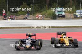 Carlos Sainz Jr (ESP) Scuderia Toro Rosso STR11 and Kevin Magnussen (DEN) Renault Sport F1 Team RS16 battle for position. 31.07.2016. Formula 1 World Championship, Rd 12, German Grand Prix, Hockenheim, Germany, Race Day.