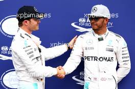 Nico Rosberg (GER) Mercedes AMG Petronas F1 W07 gets pole position and shakes hand with Lewis Hamilton (GBR) Mercedes AMG F1 W07 . 30.07.2016. Formula 1 World Championship, Rd 12, German Grand Prix, Hockenheim, Germany, Qualifying Day.