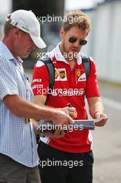Sebastian Vettel (GER) Ferrari signs autographs for the fans. 31.07.2016. Formula 1 World Championship, Rd 12, German Grand Prix, Hockenheim, Germany, Race Day.