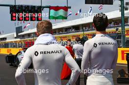 (L to R): Kevin Magnussen (DEN) Renault Sport F1 Team and team mate Jolyon Palmer (GBR) Renault Sport F1 Team as the grid observes the national anthem. 24.07.2016. Formula 1 World Championship, Rd 11, Hungarian Grand Prix, Budapest, Hungary, Race Day.
