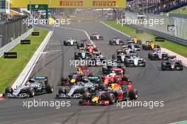 (L to R): Lewis Hamilton (GBR) Mercedes AMG F1; Nico Rosberg (GER) Mercedes AMG F1; and Daniel Ricciardo (AUS) Red Bull Racing battle for the lead at the start of the race. 24.07.2016. Formula 1 World Championship, Rd 11, Hungarian Grand Prix, Budapest, Hungary, Race Day.
