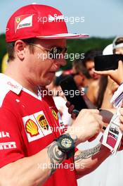 Kimi Raikkonen (FIN) Ferrari signs autographs for the fans. 23.07.2016. Formula 1 World Championship, Rd 11, Hungarian Grand Prix, Budapest, Hungary, Qualifying Day.