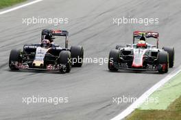 Daniil Kvyat (RUS) Scuderia Toro Rosso STR11 and Esteban Gutierrez (MEX) Haas F1 Team VF-16 battle for position. 04.09.2016. Formula 1 World Championship, Rd 14, Italian Grand Prix, Monza, Italy, Race Day.