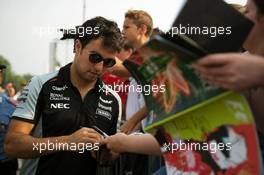 Sergio Perez (MEX) Sahara Force India F1 signs autographs for the fans. 03.09.2016. Formula 1 World Championship, Rd 14, Italian Grand Prix, Monza, Italy, Qualifying Day.