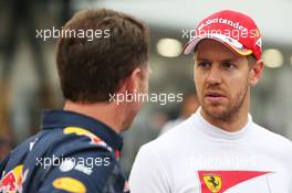 (L to R): Christian Horner (GBR) Red Bull Racing Team Principal with Sebastian Vettel (GER) Ferrari. 08.10.2016. Formula 1 World Championship, Rd 17, Japanese Grand Prix, Suzuka, Japan, Qualifying Day.