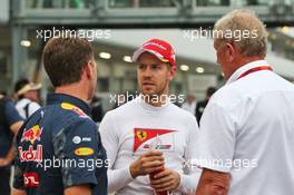 (L to R): Christian Horner (GBR) Red Bull Racing Team Principal with Sebastian Vettel (GER) Ferrari and Dr Helmut Marko (AUT) Red Bull Motorsport Consultant. 08.10.2016. Formula 1 World Championship, Rd 17, Japanese Grand Prix, Suzuka, Japan, Qualifying Day.