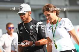 (L to R): Lewis Hamilton (GBR) Mercedes AMG F1 with Rosa Herrero Venegas (RSA) Mercedes AMG F1 Press Officer. 06.10.2016. Formula 1 World Championship, Rd 17, Japanese Grand Prix, Suzuka, Japan, Preparation Day.