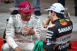 (L to R): Race winner Lewis Hamilton (GBR) Mercedes AMG F1 with third placed Sergio Perez (MEX) Sahara Force India F1 at the podium. 29.05.2015. Formula 1 World Championship, Rd 6, Monaco Grand Prix, Monte Carlo, Monaco, Race Day.