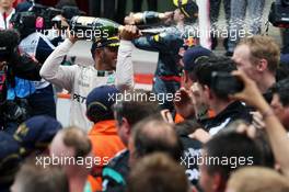 Race winner Lewis Hamilton (GBR) Mercedes AMG F1 celebrates with the champagne with the team. 29.05.2015. Formula 1 World Championship, Rd 6, Monaco Grand Prix, Monte Carlo, Monaco, Race Day.