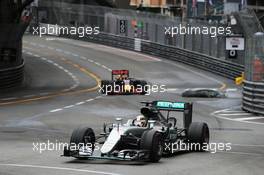 Lewis Hamilton (GBR) Mercedes AMG F1 W07 Hybrid leads Daniel Ricciardo (AUS) Red Bull Racing RB12 as debris falls onto the circuit. 29.05.2015. Formula 1 World Championship, Rd 6, Monaco Grand Prix, Monte Carlo, Monaco, Race Day.