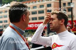 (L to R): Mario Isola (ITA) Pirelli Racing Manager with Sebastian Vettel (GER) Ferrari. 26.05.2016. Formula 1 World Championship, Rd 6, Monaco Grand Prix, Monte Carlo, Monaco, Practice Day.