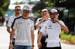 (L to R): Esteban Gutierrez (MEX) Haas F1 Team with Fernando Alonso (ESP) McLaren. 30.09.2016. Formula 1 World Championship, Rd 16, Malaysian Grand Prix, Sepang, Malaysia, Friday.