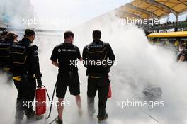 The Renault Sport F1 Team RS16 of Kevin Magnussen (DEN) is tended to by marshals and mechanics after it caught fire in the pits in the first practice session. 30.09.2016. Formula 1 World Championship, Rd 16, Malaysian Grand Prix, Sepang, Malaysia, Friday.