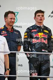 Max Verstappen (NLD) Red Bull Racing and Christian Horner (GBR) Red Bull Racing Team Principal on the podium. 02.10.2016. Formula 1 World Championship, Rd 16, Malaysian Grand Prix, Sepang, Malaysia, Sunday.