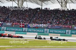 Lewis Hamilton (GBR) Mercedes AMG F1 W07 Hybrid leads at the start of the race as Nico Rosberg (GER) Mercedes AMG F1 W07 Hybrid and Sebastian Vettel (GER) Ferrari SF16-H collide. 02.10.2016. Formula 1 World Championship, Rd 16, Malaysian Grand Prix, Sepang, Malaysia, Sunday.