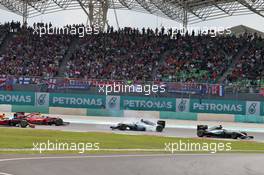 Lewis Hamilton (GBR) Mercedes AMG F1 W07 Hybrid leads at the start of the race as Nico Rosberg (GER) Mercedes AMG F1 W07 Hybrid and Sebastian Vettel (GER) Ferrari SF16-H collide. 02.10.2016. Formula 1 World Championship, Rd 16, Malaysian Grand Prix, Sepang, Malaysia, Sunday.