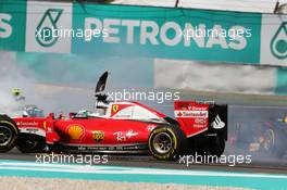Sebastian Vettel (GER) Ferrari SF16-H and Nico Rosberg (GER) Mercedes AMG F1 W07 Hybrid collide at the start of the race. 02.10.2016. Formula 1 World Championship, Rd 16, Malaysian Grand Prix, Sepang, Malaysia, Sunday.