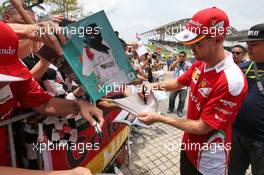 Sebastian Vettel (GER) Ferrari signs autographs for the fans. 01.10.2016. Formula 1 World Championship, Rd 16, Malaysian Grand Prix, Sepang, Malaysia, Saturday.