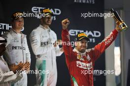 Sebastian Vettel (GER) Ferrari celebrates his third position on the podium. 27.11.2016. Formula 1 World Championship, Rd 21, Abu Dhabi Grand Prix, Yas Marina Circuit, Abu Dhabi, Race Day.