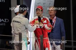 (L to R): Nico Rosberg (GER) Mercedes AMG F1 celebrates his World Championship on the podium with Sebastian Vettel (GER) Ferrari.. 27.11.2016. Formula 1 World Championship, Rd 21, Abu Dhabi Grand Prix, Yas Marina Circuit, Abu Dhabi, Race Day.