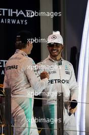 The podium (L to R): World Champion Nico Rosberg (GER) Mercedes AMG F1 shakes hands with team mate and race winner Lewis Hamilton (GBR) Mercedes AMG F1. 27.11.2016. Formula 1 World Championship, Rd 21, Abu Dhabi Grand Prix, Yas Marina Circuit, Abu Dhabi, Race Day.
