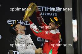 (L to R): second placed Nico Rosberg (GER) Mercedes AMG F1 celebrates his World Championship on the podium with Sebastian Vettel (GER) Ferrari. 27.11.2016. Formula 1 World Championship, Rd 21, Abu Dhabi Grand Prix, Yas Marina Circuit, Abu Dhabi, Race Day.