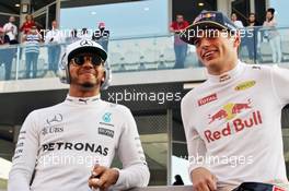 (L to R): Lewis Hamilton (GBR) Mercedes AMG F1 with Max Verstappen (NLD) Red Bull Racing on the drivers parade. 27.11.2016. Formula 1 World Championship, Rd 21, Abu Dhabi Grand Prix, Yas Marina Circuit, Abu Dhabi, Race Day.