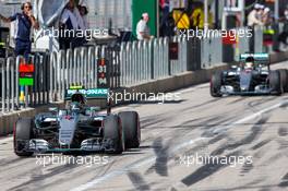 Nico Rosberg (GER) Mercedes AMG F1 W07 Hybrid leads team mate Lewis Hamilton (GBR) Mercedes AMG F1 W07 Hybrid out of the pits. 22.10.2016. Formula 1 World Championship, Rd 18, United States Grand Prix, Austin, Texas, USA, Qualifying Day.
