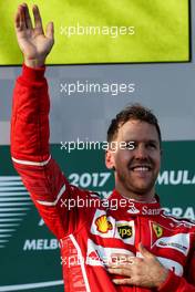 Race winner Sebastian Vettel (GER) Ferrari celebrates on the podium. 26.03.2017. Formula 1 World Championship, Rd 1, Australian Grand Prix, Albert Park, Melbourne, Australia, Race Day.