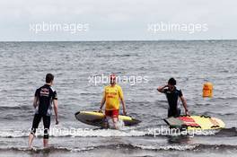 Daniil Kvyat (RUS) Scuderia Toro Rosso and Carlos Sainz Jr (ESP) Scuderia Toro Rosso on St Kilda Beach with the St Kilda Lifesaving Club. 22.03.2017. Formula 1 World Championship, Rd 1, Australian Grand Prix, Albert Park, Melbourne, Australia, Preparation Day.