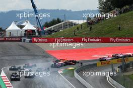 Daniil Kvyat (RUS) Scuderia Toro Rosso STR12 locks up under braking at the start of the race, hitting Fernando Alonso (ESP) McLaren MCL32 and Max Verstappen (NLD) Red Bull Racing RB13. 09.07.2017. Formula 1 World Championship, Rd 9, Austrian Grand Prix, Spielberg, Austria, Race Day.