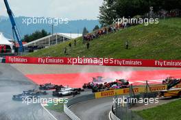 Daniil Kvyat (RUS) Scuderia Toro Rosso STR12 locks up under braking at the start of the race, hitting Fernando Alonso (ESP) McLaren MCL32 and Max Verstappen (NLD) Red Bull Racing RB13. 09.07.2017. Formula 1 World Championship, Rd 9, Austrian Grand Prix, Spielberg, Austria, Race Day.