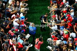 Daniil Kvyat (RUS) Scuderia Toro Rosso signs autographs for the fans. 08.07.2017. Formula 1 World Championship, Rd 9, Austrian Grand Prix, Spielberg, Austria, Qualifying Day.