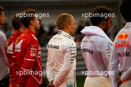 Lewis Hamilton (GBR) Mercedes AMG F1 and Valtteri Bottas (FIN) Mercedes AMG F1 as the grid observes the national anthem. 16.04.2017. Formula 1 World Championship, Rd 3, Bahrain Grand Prix, Sakhir, Bahrain, Race Day.