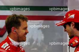 Sebastian Vettel (GER) Ferrari with Antonio Giovinazzi (ITA) Ferrari Development Driver. 15.04.2017. Formula 1 World Championship, Rd 3, Bahrain Grand Prix, Sakhir, Bahrain, Qualifying Day.