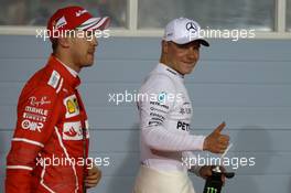 Sebastian Vettel (GER) Ferrari and Valtteri Bottas (FIN) Mercedes AMG F1 W08. 15.04.2017. Formula 1 World Championship, Rd 3, Bahrain Grand Prix, Sakhir, Bahrain, Qualifying Day.