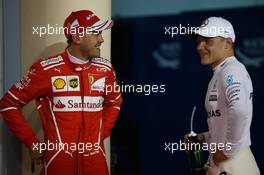 Sebastian Vettel (GER) Ferrari SF70H and Valtteri Bottas (FIN) Mercedes AMG F1 W08. 15.04.2017. Formula 1 World Championship, Rd 3, Bahrain Grand Prix, Sakhir, Bahrain, Qualifying Day.