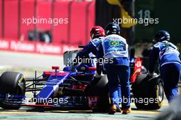 The Scuderia Toro Rosso STR12 of Brendon Hartley (NZL) is pushed off the circuit by marshals in the first practice session. 10.11.2017. Formula 1 World Championship, Rd 19, Brazilian Grand Prix, Sao Paulo, Brazil, Practice Day.