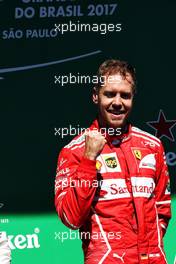 Race winner Sebastian Vettel (GER) Ferrari celebrates on the podium. 12.11.2017. Formula 1 World Championship, Rd 19, Brazilian Grand Prix, Sao Paulo, Brazil, Race Day.