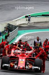 The Ferrari SF70Hs of Sebastian Vettel (GER) Ferrari and Kimi Raikkonen (FIN) Ferrari are pushed into parc ferme by mechanics after qualifying. 11.11.2017. Formula 1 World Championship, Rd 19, Brazilian Grand Prix, Sao Paulo, Brazil, Qualifying Day.