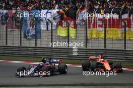 Carlos Sainz Jr (ESP) Scuderia Toro Rosso STR12 and Fernando Alonso (ESP) McLaren MCL32 battle for position. 09.04.2017. Formula 1 World Championship, Rd 2, Chinese Grand Prix, Shanghai, China, Race Day.