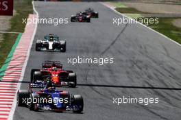 Carlos Sainz Jr (ESP) Scuderia Toro Rosso STR12 leads Sebastian Vettel (GER) Ferrari SF70H and Lewis Hamilton (GBR) Mercedes AMG F1 W08. 14.05.2017. Formula 1 World Championship, Rd 5, Spanish Grand Prix, Barcelona, Spain, Race Day.