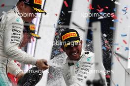 Race winner Lewis Hamilton (GBR) Mercedes AMG F1 celebrates on the podium with team mate Valtteri Bottas (FIN) Mercedes AMG F1. 16.07.2017. Formula 1 World Championship, Rd 10, British Grand Prix, Silverstone, England, Race Day.