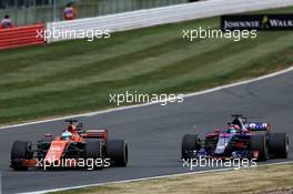 Fernando Alonso (ESP) McLaren MCL32 and Daniil Kvyat (RUS) Scuderia Toro Rosso STR12 battle for position. 16.07.2017. Formula 1 World Championship, Rd 10, British Grand Prix, Silverstone, England, Race Day.