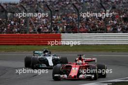Sebastian Vettel (GER) Ferrari SF70H leads Valtteri Bottas (FIN) Mercedes AMG F1 W08. 16.07.2017. Formula 1 World Championship, Rd 10, British Grand Prix, Silverstone, England, Race Day.