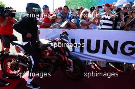 Lewis Hamilton (GBR) Mercedes AMG F1 with fans on his motorbike. 29.07.2017. Formula 1 World Championship, Rd 11, Hungarian Grand Prix, Budapest, Hungary, Qualifying Day.